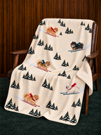 Pomeranian beige Christmas skiing fleece blanket — chair view